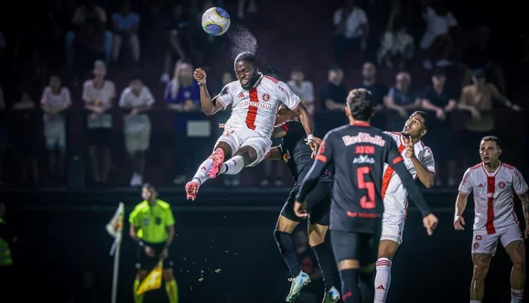 Enner Valencia com a camisa branca do Inter dá salto no ar, cabeceando a bola, na partida contra o Red Bull Bragantino