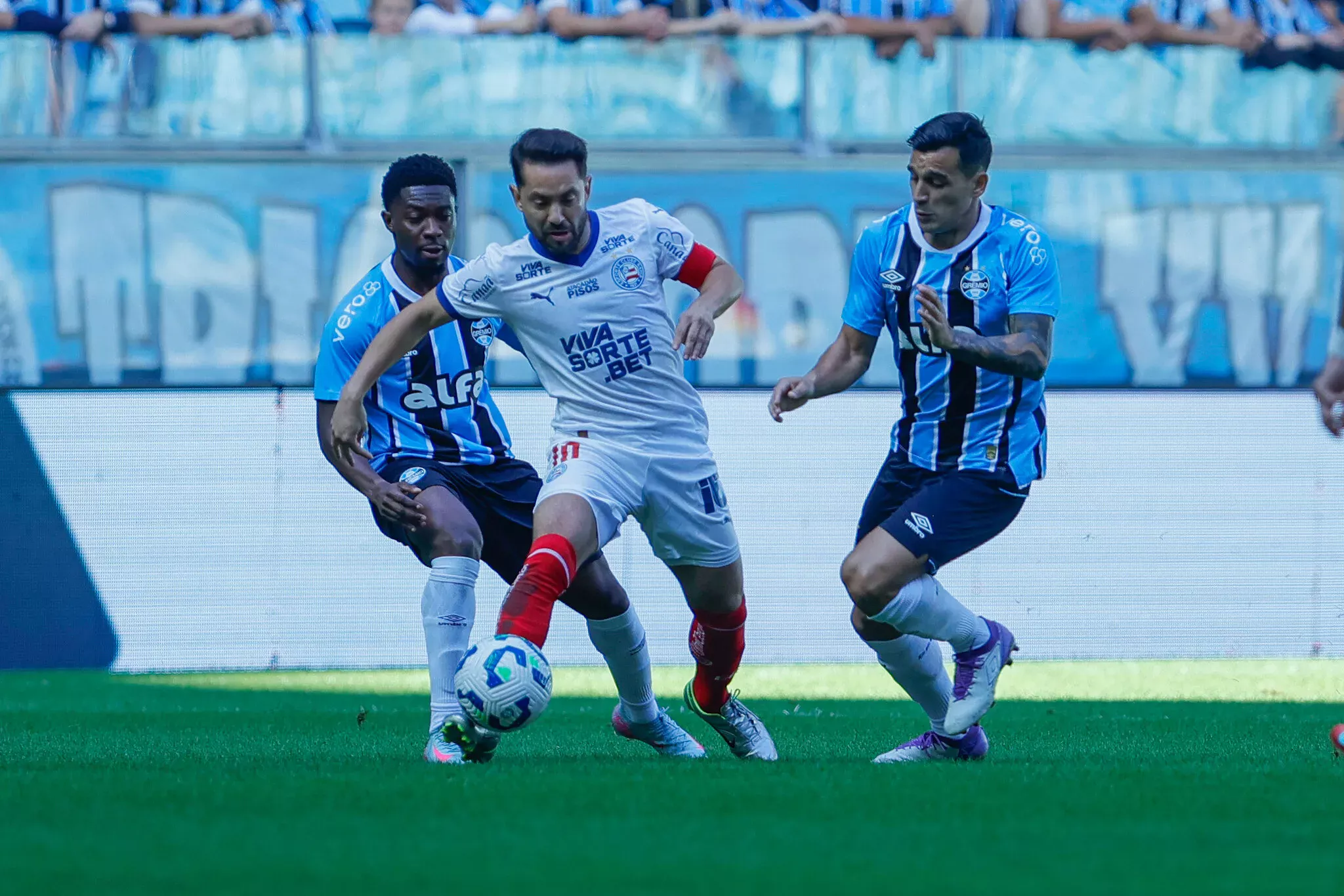 Everton Ribeiro jogador do Bahia disputando a bola com jogadores do Grêmio